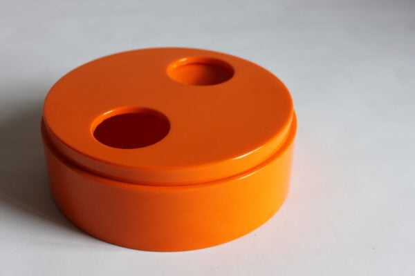 Round orange lidded melamine trinket bowl by Sergio Asti for Bilumen, the bottom has two teardrop shaped holes. The top twists to make the holes more or less shallow | Century Soup |