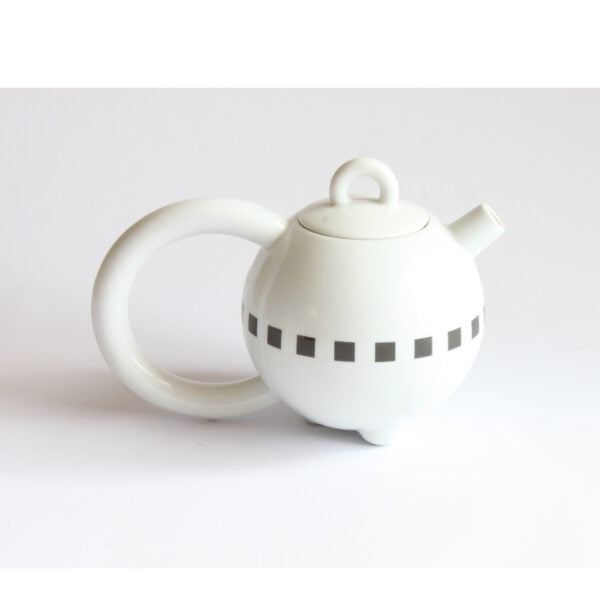 A pure Memphis style teapot by Matteo Thun for Arzberg Porzellan Germany. Named "Fantasia". Round body with a oversized round handle, a very small handle on the lid. Decorated around with a black blocks. Released at the "Think big" 1989 Milan furniture fair.
