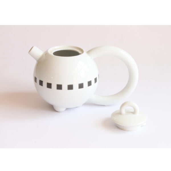 A pure Memphis style teapot by Matteo Thun for Arzberg Porzellan Germany. Named "Fantasia". Round body with a oversized round handle, a very small handle on the lid. Decorated around with a black blocks. Released at the "Think big" 1989 Milan furniture fair.