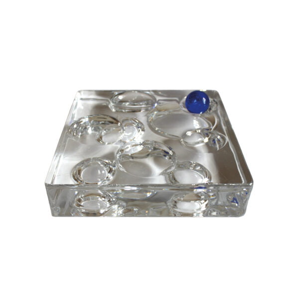 A playful square solid crystal sculpture with a moon crater landscape bubble surface on both sides. Perhaps the holes can be used to place various trinkets or jewelry. With it comes a cobalt blue marble. Made by Daum Nancy, France | Century Soup |