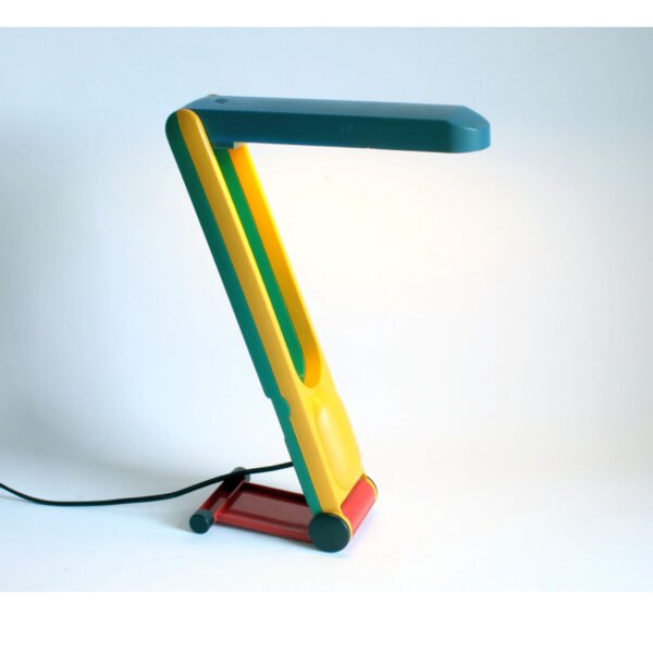 A very very 1980s desk or table lamp in primary green, blue, yellow and red colors. It can be adjusted in height and it can be folded. Century soup vintage design antiques curiosa collectibles antwerp.