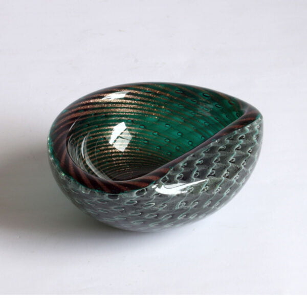 A gold flecked striped green bullicante and filigrana technique bowl, murano 1950. Filigree glass is made with colorless, white, and sometimes colored canes. Filigrana originated on the island of Murano in the 16th century and continued until the 18th century. It saw a revival in the 19th century. The bullicante technique inserts layers of bubbles into the glass in a grid pattern | Century Soup |