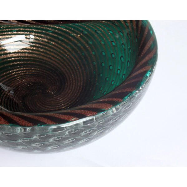 A gold flecked striped green bullicante and filigrana technique bowl, murano 1950. Filigree glass is made with colorless, white, and sometimes colored canes. Filigrana originated on the island of Murano in the 16th century and continued until the 18th century. It saw a revival in the 19th century. The bullicante technique inserts layers of bubbles into the glass in a grid pattern | Century Soup |