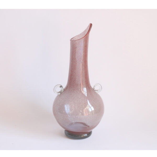 A handblown pink glass vase with little ears, 1960s. The technique used is pulegoso. From the corning museum glass definitions: (italian, from the dialect word pulega, “bubble”) glass containing numerous bubbles of all sizes, produced by adding bicarbonate of soda, gasoline, or other substances to the melt. The bubbles make the glass semi-opaque and give the surface an irregular texture. Pulegoso was developed by napoleone martinuzzi (1892-1977) on the island of murano, italy, in the 1920s. Century soup vintage design antiques curiosa collectibles antwerp.