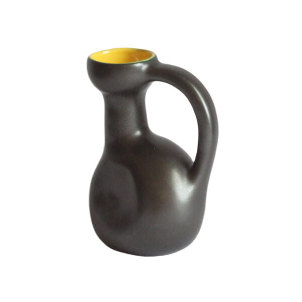 A zoomorphic 1950s ceramic pitcher in black and yellow glazing. Typical 1950s shape abstracted from an animal shape. Signed underneath "vallauris", probably elchinger | Century Soup |