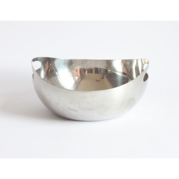 A single round organic shaped stainless steel bowl, the sides protrude upwards and make room for the handles holes