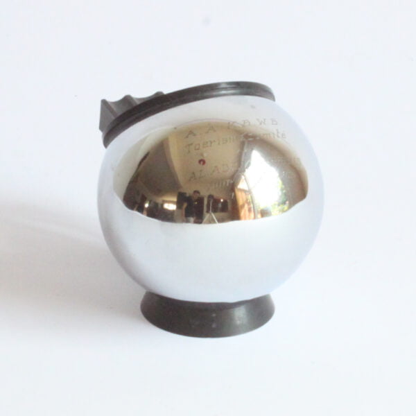 A chrome ball, bakelite base, three steel wires hold the cigarettes. Art deco ball ashtray by Demeyere Belgium.