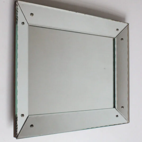 Art deco classic picture frame style shadow box mirror with scalloped edges. The frame is made of mirrored glass at an angle, creating a depth.