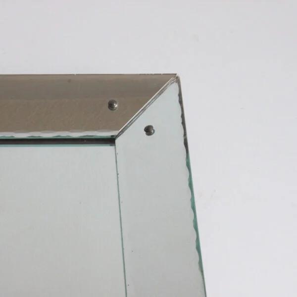 Art deco classic picture frame style shadow box mirror with scalloped edges. The frame is made of mirrored glass at an angle, creating a depth.