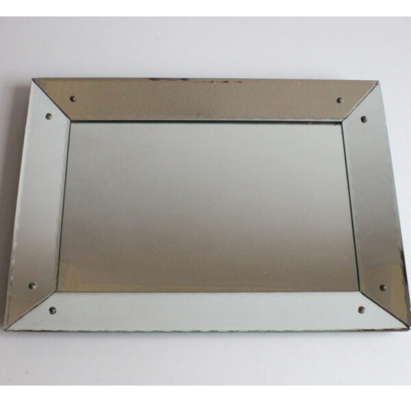 Art deco classic picture frame style shadow box mirror with scalloped edges. The frame is made of mirrored glass at an angle, creating a depth.
