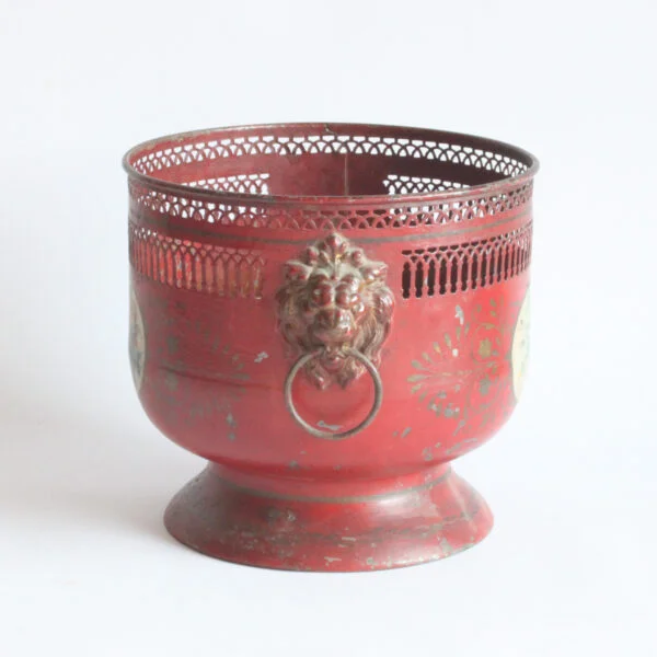 A painted toleware pedestal jardiniere with dog handles and a flower decor, france early 20th century. Cylindrical body on a pedestal, the rim is punctured to resemble archways and columns | Century Soup |