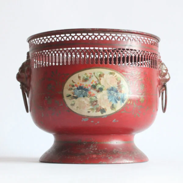 A painted toleware pedestal jardiniere with dog handles and a flower decor, france early 20th century. Cylindrical body on a pedestal, the rim is punctured to resemble archways and columns | Century Soup |