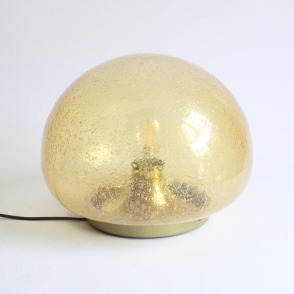 A bubble glas or "Pulegoso" technique wall or ceiling lamp by Glashütte Limburg, Germany 1970s. The shade is blown in a mushroom shape, and sits on a round brass base. The bulb is held inside on a reclining brass cone.