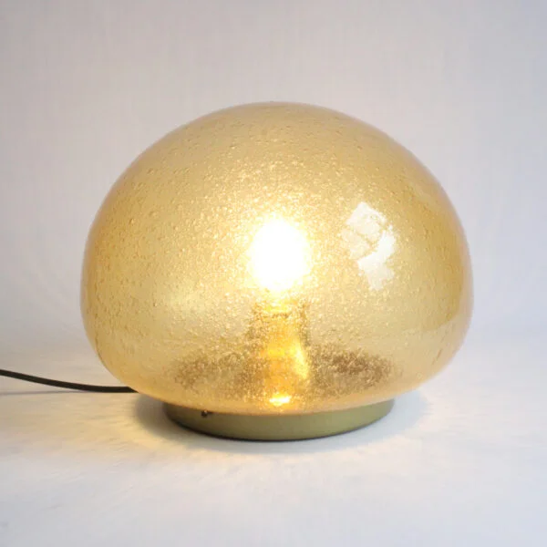 A bubble glas or "Pulegoso" technique wall or ceiling lamp by Glashütte Limburg, Germany 1970s. The shade is blown in a mushroom shape, and sits on a round brass base. The bulb is held inside on a reclining brass cone.
