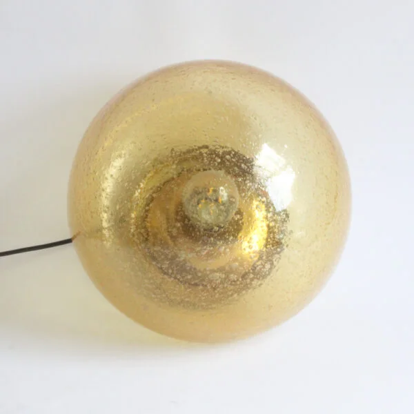A bubble glas or "Pulegoso" technique wall or ceiling lamp by Glashütte Limburg, Germany 1970s. The shade is blown in a mushroom shape, and sits on a round brass base. The bulb is held inside on a reclining brass cone.