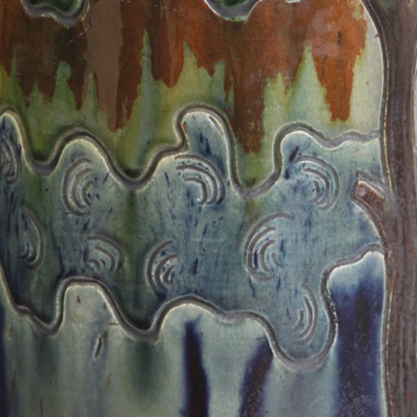 A large flemish earthenware pedestal jardiniere by laigneil, kortijk belgium 1900s. Influences of art nouveau, folk art, arts & crafts, naturalism. Executed in flemish earthenware decorated with a sgraffito technique, shades blue brown and green glazing. Very natural colors. On the cache-pot a scene of farmers and nuns, and trees all around. The pedestal decorated with tall trees and castles, a river below and layers of sky / clouds / forest | Century Soup |