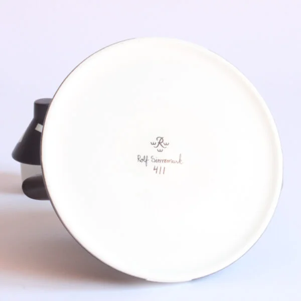 Memphis style teapot by rolf sinnemark for rörstrand, sweden 1985. Model 411, a conical shaped porcelain teapot in black. Seemingly rand placed white geometrical shapes cover the surface | Century Soup |