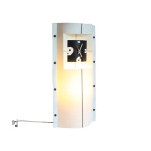 Slamp timelight by Romeo Guaricci & Samuel Parker A very 1990s style table clock by Slamp, Timelight. Consists of two bent opaque Opalflex® panels bolted together near the sides, creating a tubular frame with a clock and a light inside. Black striped extend from the clock to the lamp frame | Century Soup |