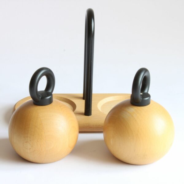 A set of pepper and salt mills / grinders designed by Richard Nissen & Carsten Jørgensen for Bodum, Denmark. The round beech wooden bodies with and castiron O-ring shaped handles. A beech wooden tray with a castiron handle serves as the base of the vintage condiment set | Century Soup |