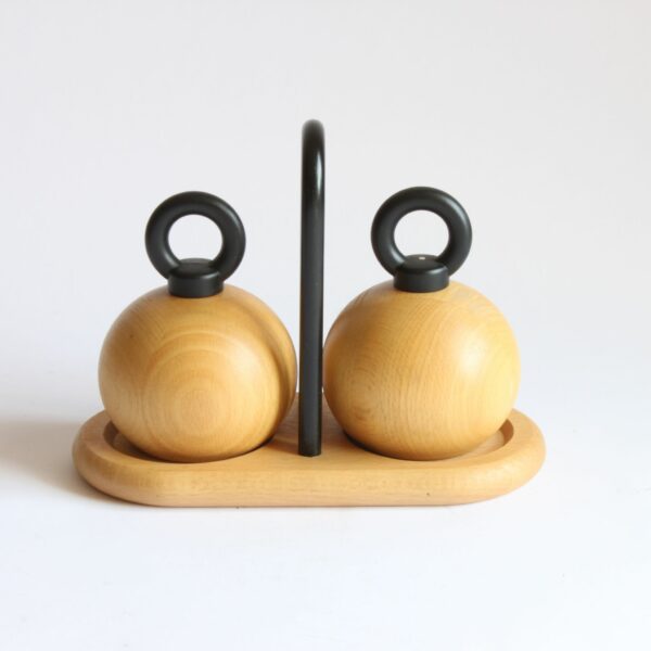 A set of pepper and salt mills / grinders designed by Richard Nissen & Carsten Jørgensen for Bodum, Denmark. The round beech wooden bodies with and castiron O-ring shaped handles. A beech wooden tray with a castiron handle serves as the base of the vintage condiment set | Century Soup |