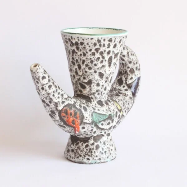 A very 1950s vintage organic shaped vase or pitcher by Marius Bessone, Vallauris 1950s. In a white / black lava glaze with geometric figures in green, red, yellow and blue mid century modern | Century Soup |