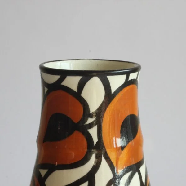 A Schramberg majolica vase, hand painted in black, orange and white floral decor. Attributed to Eva Zeisel | Century Soup |