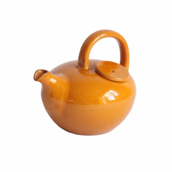 A vintage artisanal Scandinavian modern style pottery teapot in a beige color. Rounded body with a large handle and the lid on the left side. The Ildfast collection was produced from 1941 till the 1960s. Marked underneat: BS for Brack and Sønner Denmark Century soup vintage design antiques curiosa collectibles antwerp.