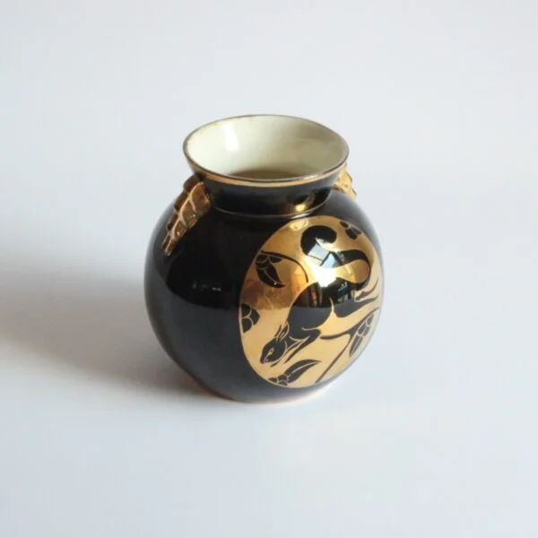 A black and gold decorated art deco vase with a squirrel. Ball shaped with stepped ears in typical art deco style. Designed by Charles Catteau for Boch Keramis, Belgium. Model number D.2137. Century soup vintage design antiques curiosa collectibles antwerp.