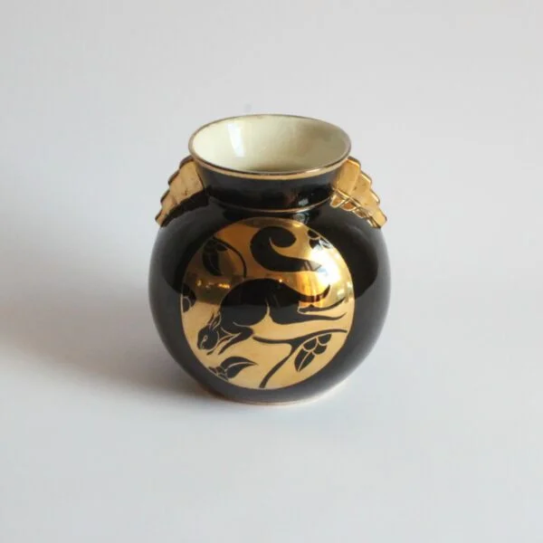 A black and gold decorated art deco vase with a squirrel. Ball shaped with stepped ears in typical art deco style. Designed by Charles Catteau for Boch Keramis, Belgium. Model number D.2137. Century soup vintage design antiques curiosa collectibles antwerp.