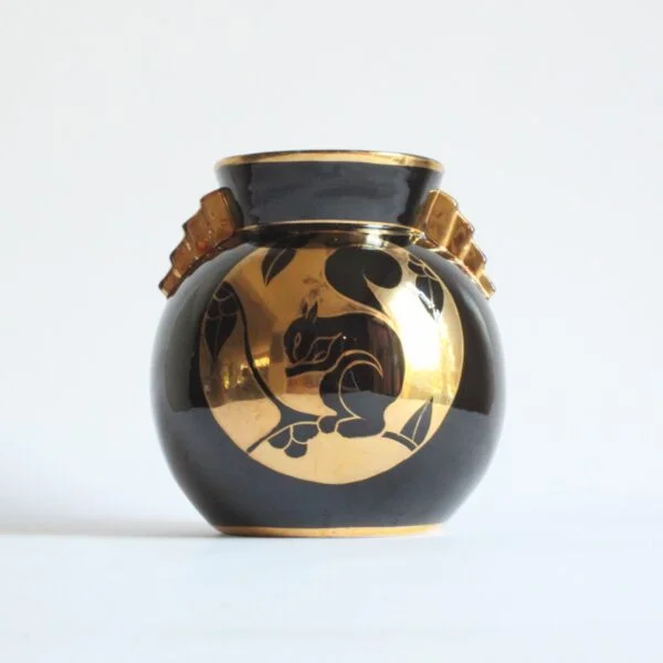 A black and gold decorated art deco vase with a squirrel. Ball shaped with stepped ears in typical art deco style. Designed by Charles Catteau for Boch Keramis, Belgium. Model number D.2137. Century soup vintage design antiques curiosa collectibles antwerp.