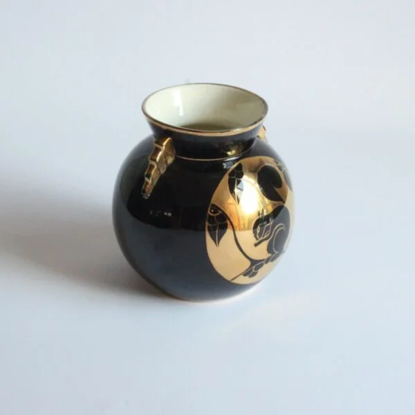 A black and gold decorated art deco vase with a squirrel. Ball shaped with stepped ears in typical art deco style. Designed by Charles Catteau for Boch Keramis, Belgium. Model number D.2137. Century soup vintage design antiques curiosa collectibles antwerp.