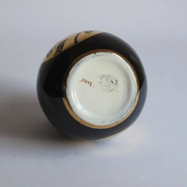 A black and gold decorated art deco vase with a squirrel. Ball shaped with stepped ears in typical art deco style. Designed by Charles Catteau for Boch Keramis, Belgium. Model number D.2137. Century soup vintage design antiques curiosa collectibles antwerp.
