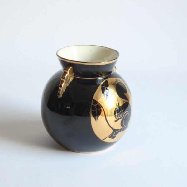 A black and gold decorated art deco vase with a squirrel. Ball shaped with stepped ears in typical art deco style. Designed by Charles Catteau for Boch Keramis, Belgium. Model number D.2137. Century soup vintage design antiques curiosa collectibles antwerp.