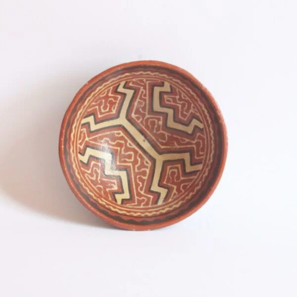A set of three Shipibo earthenware vessels with intricate geometrical patterns. Almost resembling electronic circuit boards. One bowl and two jars or pots. The Shipibo of the Ucayali River, a southern tributary of the Upper Amazone in Peru, produce some of the finest polychrome prefire slip-painted earthenware pottery in the world. Also notable is that they are one of the few indigenous groups in which the primary artists are women. The Shipibo see and hear these geometric patterns in nature and reproduce the designs on their clothing, face paint, etc... Every design carries its own specific meaning. Century soup vintage design antiques curiosa collectibles antwerp.