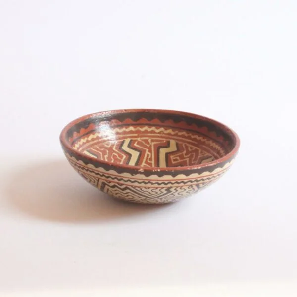 A set of three Shipibo earthenware vessels with intricate geometrical patterns. Almost resembling electronic circuit boards. One bowl and two jars or pots. The Shipibo of the Ucayali River, a southern tributary of the Upper Amazone in Peru, produce some of the finest polychrome prefire slip-painted earthenware pottery in the world. Also notable is that they are one of the few indigenous groups in which the primary artists are women. The Shipibo see and hear these geometric patterns in nature and reproduce the designs on their clothing, face paint, etc... Every design carries its own specific meaning. Century soup vintage design antiques curiosa collectibles antwerp.