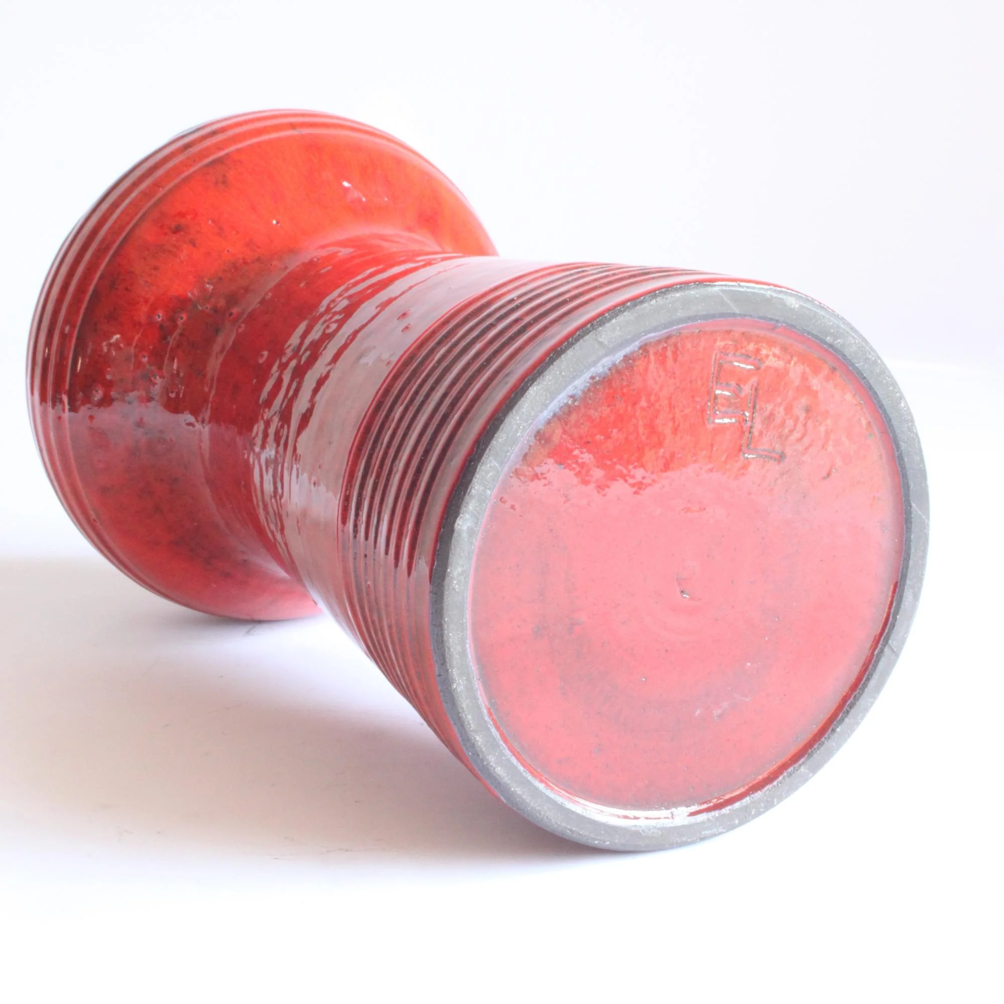 Red glazed space age style ceramic vase. Hand turned ribbed vase, round UFO-like head with four holes cutout. By Emiel Laskaris, Belgium 1960s. Emmanuel "Emiel" Laskaris was a Greek ceramic artist. He settled in Sint Niklaas and was active between the 1960s-1980s. Simultaneous with the Perignem,Amphora and Marechal ateliers. Century soup vintage design antiques curiosa collectibles antwerp.