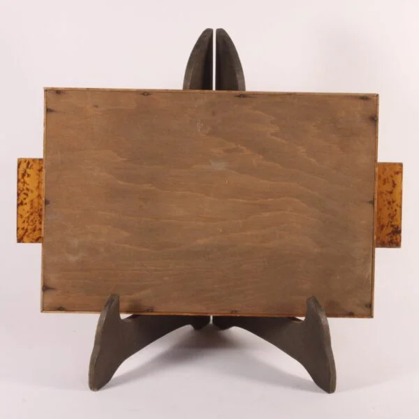 Art deco rectangular tray with an eglomisé painted glass surface and a painted wooden frame. The wood is painted with faux-bois patterns to resemble burlwood or root wood. Glass painted on underneath in typical art deco fashion, marquetry patterns in the middle and sunrays behind. Century soup vintage design antiques curiosa collectibles antwerp.