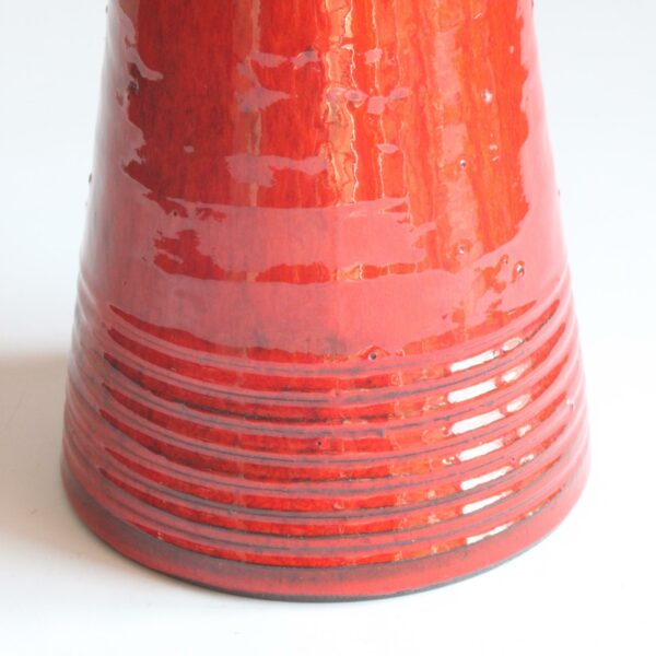 Red glazed space age style ceramic vase. Hand turned ribbed vase, round UFO-like head with four holes cutout. By Emiel Laskaris, Belgium 1960s. Emmanuel "Emiel" Laskaris was a Greek ceramic artist. He settled in Sint Niklaas and was active between the 1960s-1980s. Simultaneous with the Perignem,Amphora and Marechal ateliers. Century soup vintage design antiques curiosa collectibles antwerp.