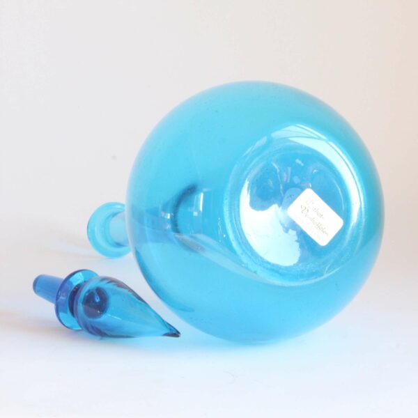A vintage sky blue "genie" bottle with stopper in transparent handblown glass from the empoli region, tuscany Italy 1960s. Condition report: Excellent condition Label underneath: Mathot Vanhoffelen, a famous Antwerp based design store well known for importing Italian glass, ceramics and design pieces. Century soup vintage design antiques curiosa collectibles antwerp.