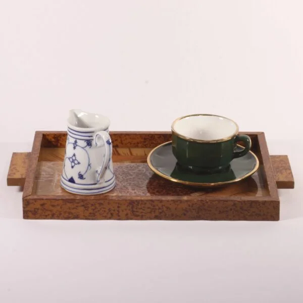 Art deco rectangular tray with an eglomisé painted glass surface and a painted wooden frame. The wood is painted with faux-bois patterns to resemble burlwood or root wood. Glass painted on underneath in typical art deco fashion, marquetry patterns in the middle and sunrays behind. Century soup vintage design antiques curiosa collectibles antwerp.