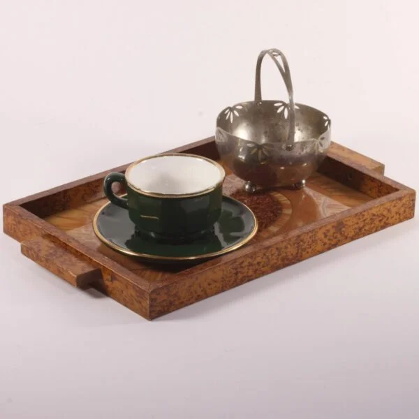 Art deco rectangular tray with an eglomisé painted glass surface and a painted wooden frame. The wood is painted with faux-bois patterns to resemble burlwood or root wood. Glass painted on underneath in typical art deco fashion, marquetry patterns in the middle and sunrays behind. Century soup vintage design antiques curiosa collectibles antwerp.
